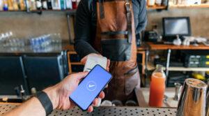 Man using contactless payment at coffee shop