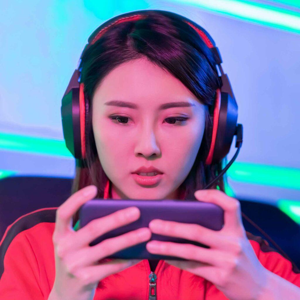 A woman playing a mobile game.