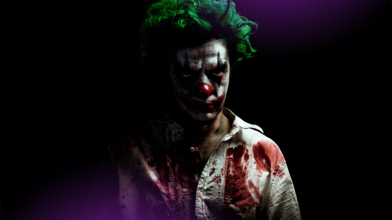 A man dressed in Joker makeup and wearing a bloodstained shirt.